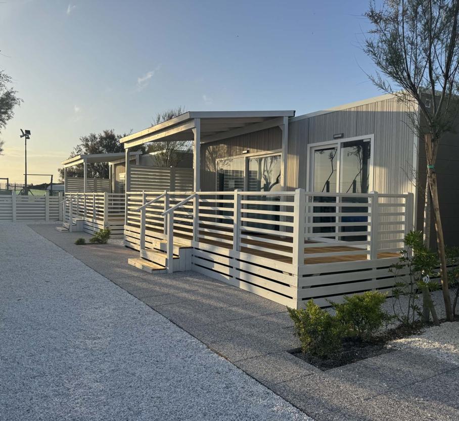 Peaceful sunset over modern homes with white decks, evoking tranquility and relaxation.