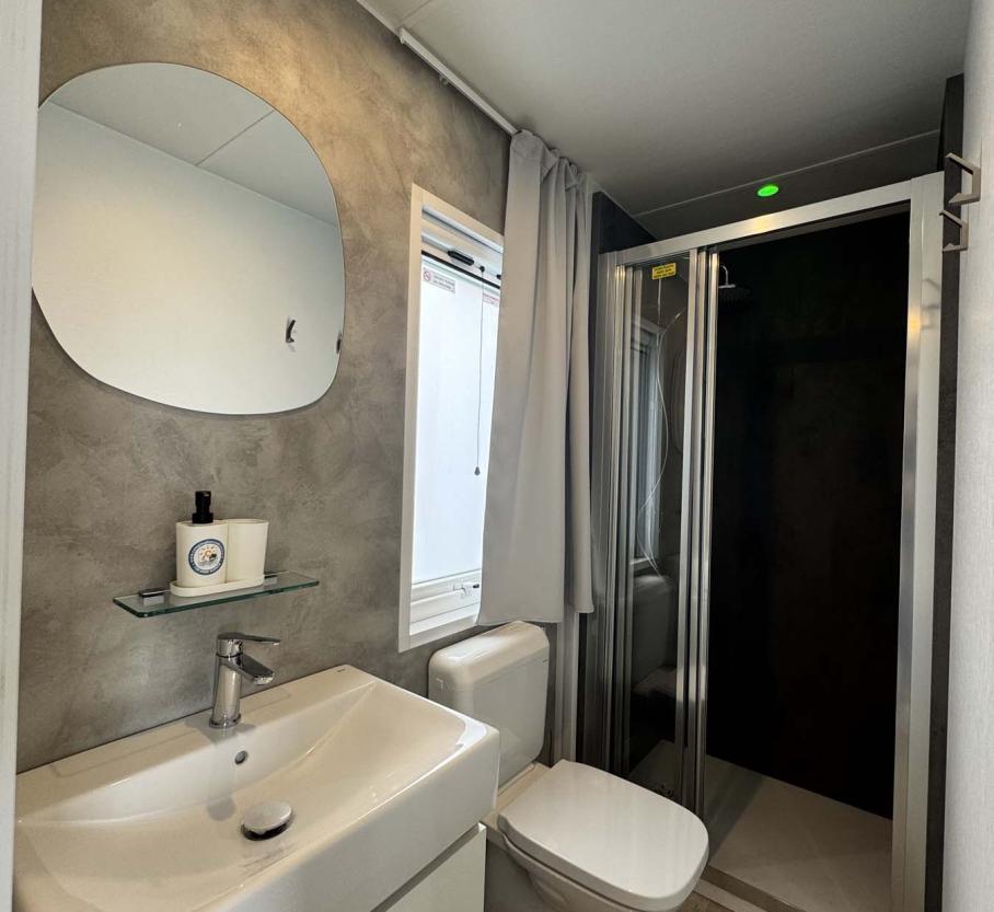 Modern, bright bathroom with elegant shower and refined details.