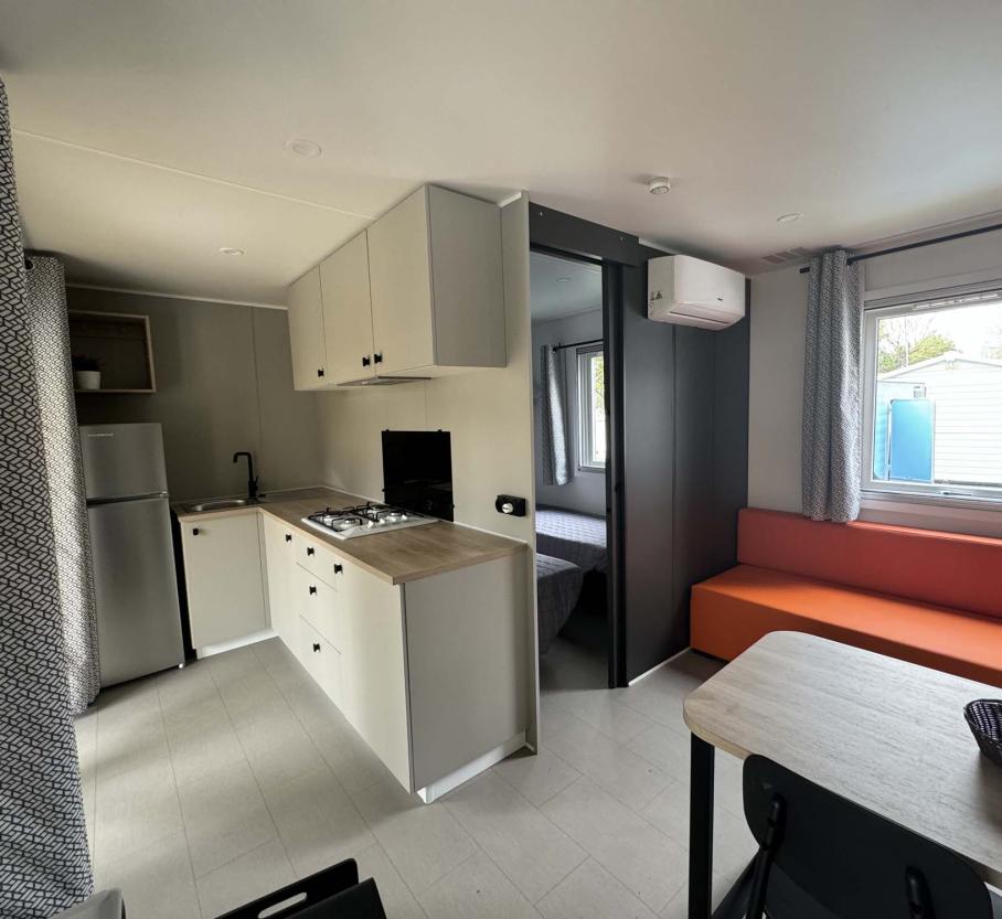 Modern studio with compact kitchen and cozy furnishings.