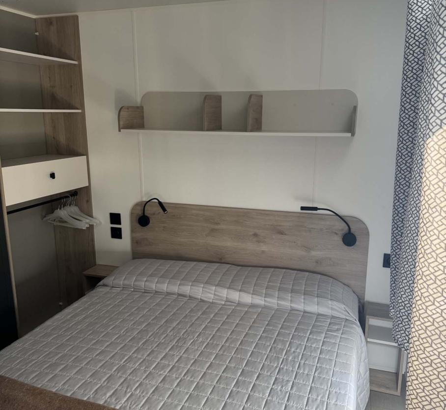 Cozy room with a double bed and warm lighting.