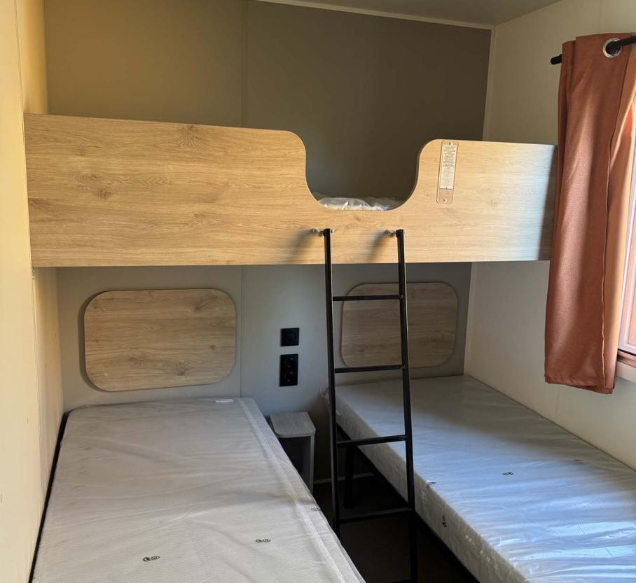 Simple room with bunk beds, cozy and bright atmosphere.