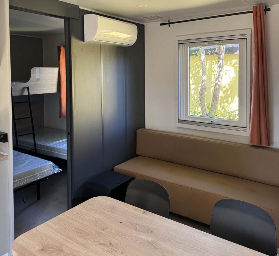 Modern, cozy interior with bunk beds and natural light.